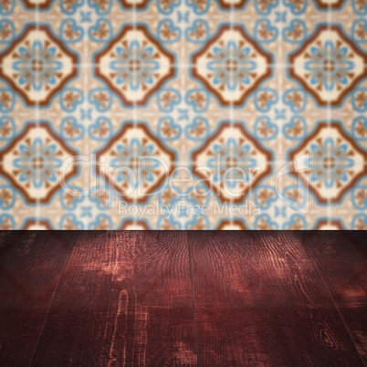 Wood table top and blur vintage ceramic tile pattern wall