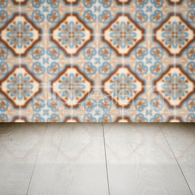 Wood table top and blur vintage ceramic tile pattern wall