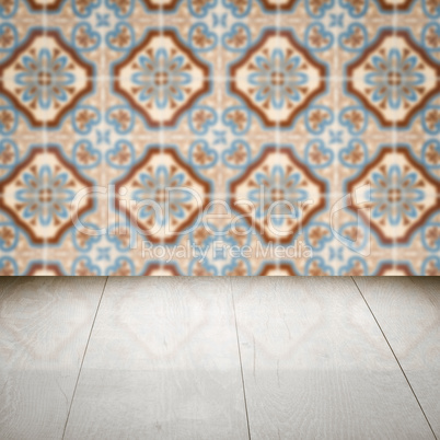 Wood table top and blur vintage ceramic tile pattern wall