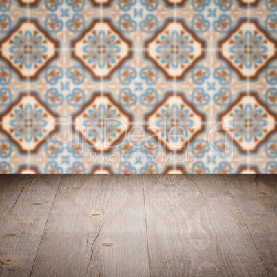 Wood table top and blur vintage ceramic tile pattern wall