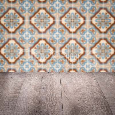 Wood table top and blur vintage ceramic tile pattern wall