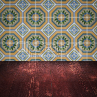 Wood table top and blur vintage ceramic tile pattern wall