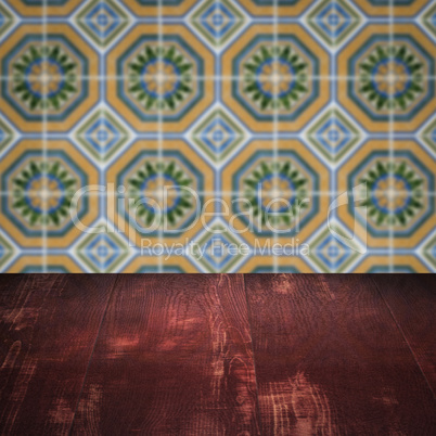 Wood table top and blur vintage ceramic tile pattern wall