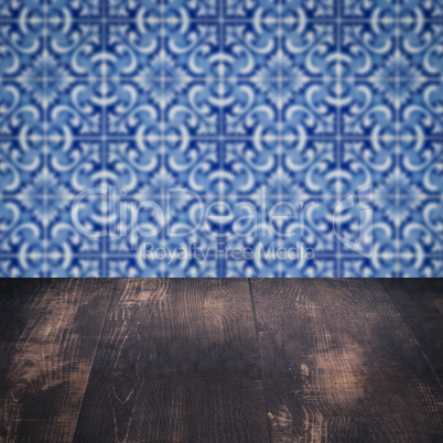 Wood table top and blur vintage ceramic tile pattern wall