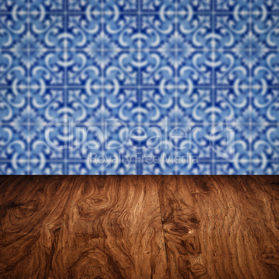 Wood table top and blur vintage ceramic tile pattern wall