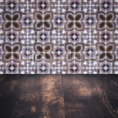 Wood table top and blur vintage ceramic tile pattern wall Wood table top and blur vintage ceramic tile pattern wall