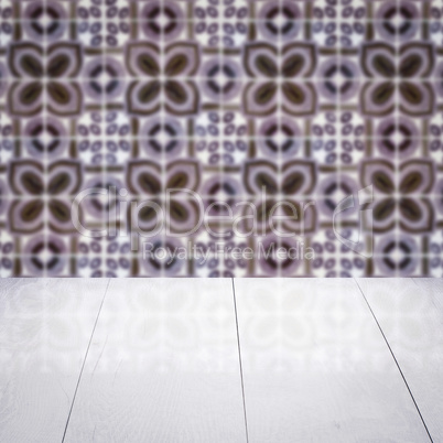 Wood table top and blur vintage ceramic tile pattern wall Wood table top and blur vintage ceramic tile pattern wall