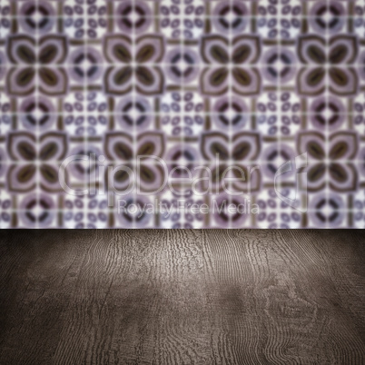 Wood table top and blur vintage ceramic tile pattern wall