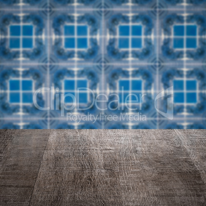 Wood table top and blur vintage ceramic tile pattern wall