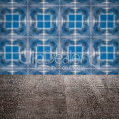 Wood table top and blur vintage ceramic tile pattern wall