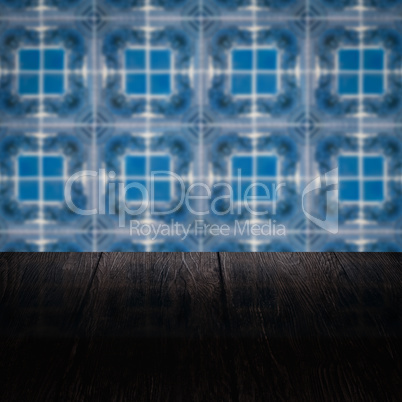 Wood table top and blur vintage ceramic tile pattern wall