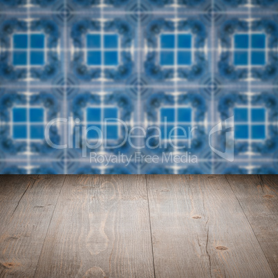 Wood table top and blur vintage ceramic tile pattern wall Wood table top and blur vintage ceramic tile pattern wall