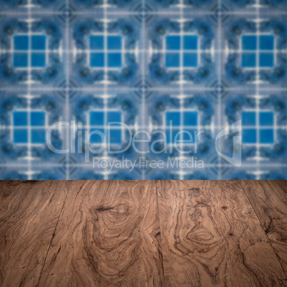 Wood table top and blur vintage ceramic tile pattern wall