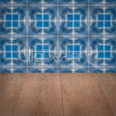 Wood table top and blur vintage ceramic tile pattern wall