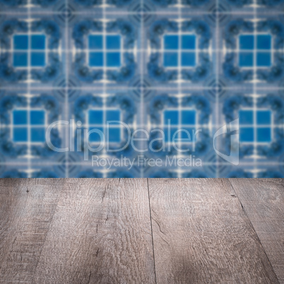 Wood table top and blur vintage ceramic tile pattern wall