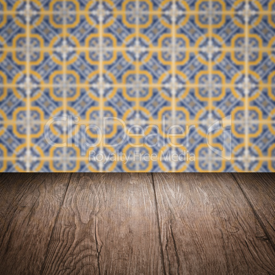 Wood table top and blur vintage ceramic tile pattern wall