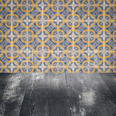 Wood table top and blur vintage ceramic tile pattern wall