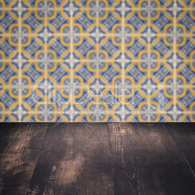 Wood table top and blur vintage ceramic tile pattern wall