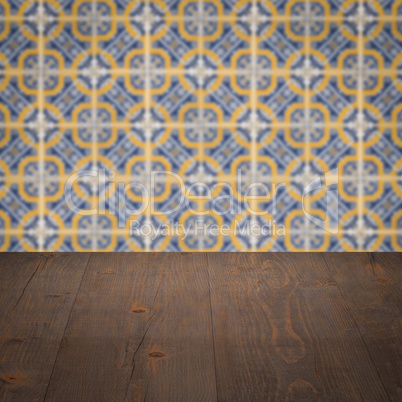 Wood table top and blur vintage ceramic tile pattern wall