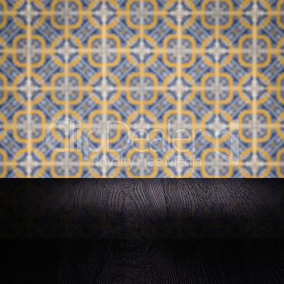 Wood table top and blur vintage ceramic tile pattern wall