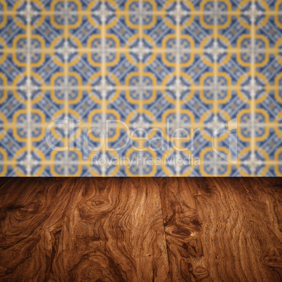 Wood table top and blur vintage ceramic tile pattern wall