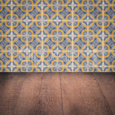 Wood table top and blur vintage ceramic tile pattern wall