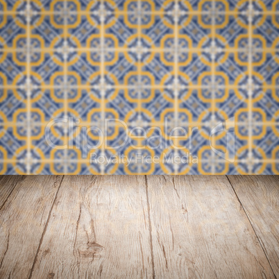 Wood table top and blur vintage ceramic tile pattern wall