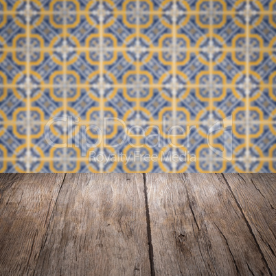 Wood table top and blur vintage ceramic tile pattern wall