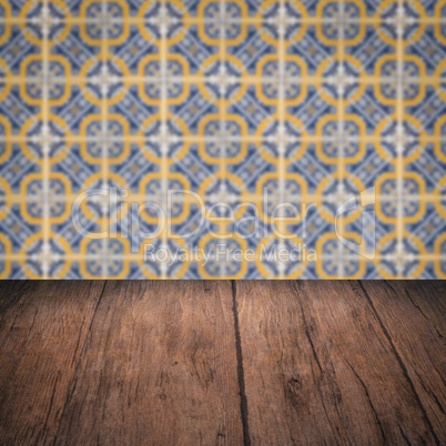 Wood table top and blur vintage ceramic tile pattern wall