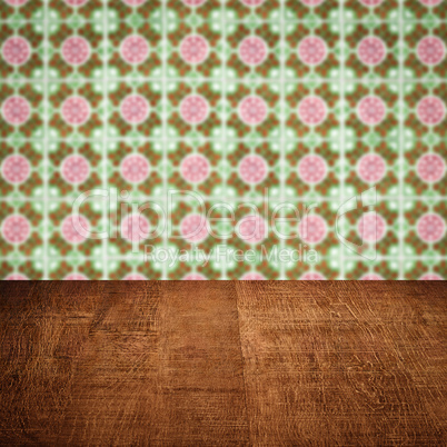 Wood table top and blur vintage ceramic tile pattern wall