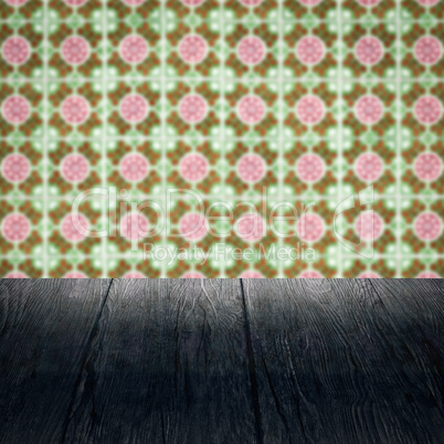 Wood table top and blur vintage ceramic tile pattern wall