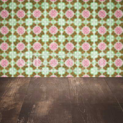 Wood table top and blur vintage ceramic tile pattern wall Wood table top and blur vintage ceramic tile pattern wall