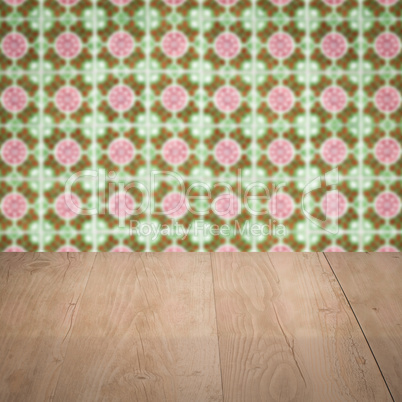 Wood table top and blur vintage ceramic tile pattern wall