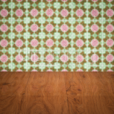 Wood table top and blur vintage ceramic tile pattern wall