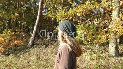 woman open her arms and enjoy the sun in autumn