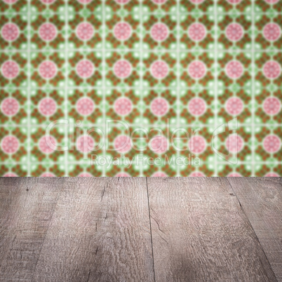 Wood table top and blur vintage ceramic tile pattern wall Wood table top and blur vintage ceramic tile pattern wall
