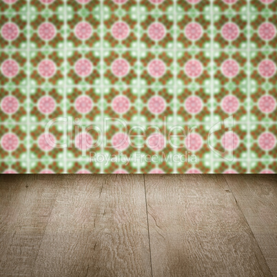 Wood table top and blur vintage ceramic tile pattern wall