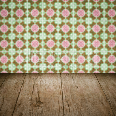 Wood table top and blur vintage ceramic tile pattern wall