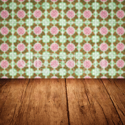 Wood table top and blur vintage ceramic tile pattern wall