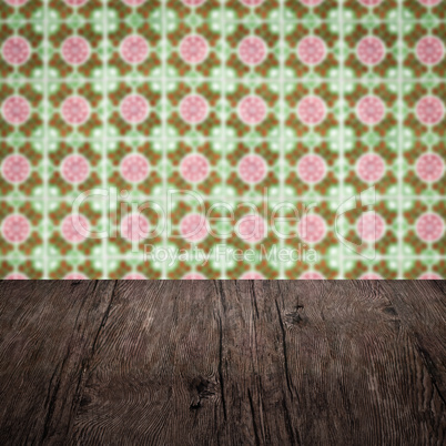 Wood table top and blur vintage ceramic tile pattern wall