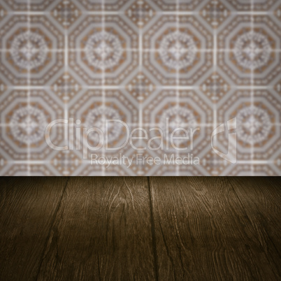 Wood table top and blur vintage ceramic tile pattern wall