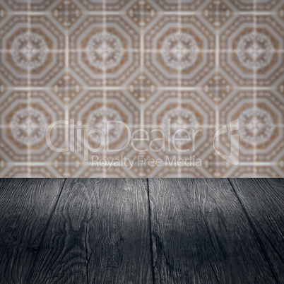 Wood table top and blur vintage ceramic tile pattern wall