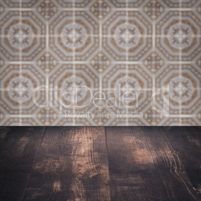 Wood table top and blur vintage ceramic tile pattern wall