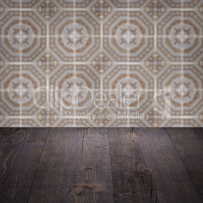 Wood table top and blur vintage ceramic tile pattern wall