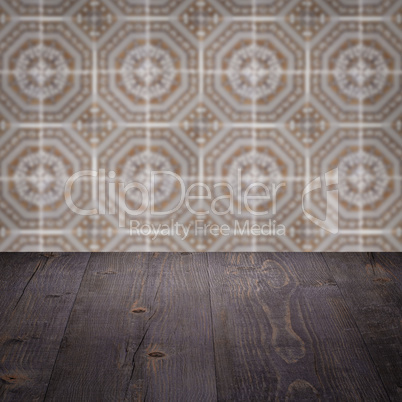 Wood table top and blur vintage ceramic tile pattern wall