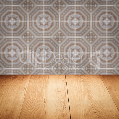 Wood table top and blur vintage ceramic tile pattern wall