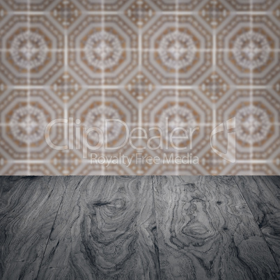 Wood table top and blur vintage ceramic tile pattern wall