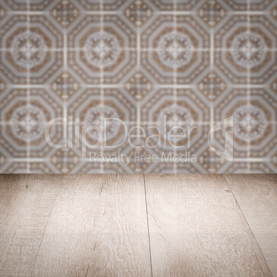 Wood table top and blur vintage ceramic tile pattern wall