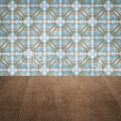 Wood table top and blur vintage ceramic tile pattern wall