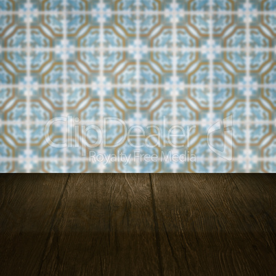 Wood table top and blur vintage ceramic tile pattern wall